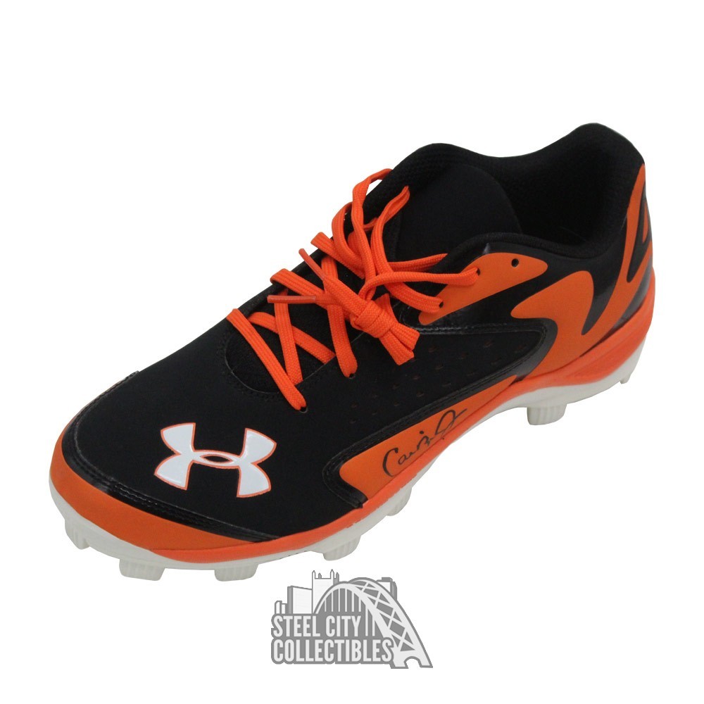 orange and black under armour baseball cleats