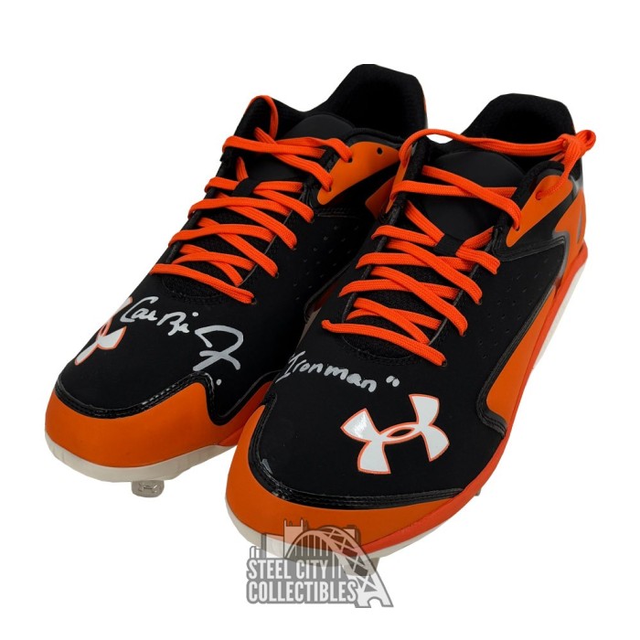 orange and black under armour baseball cleats